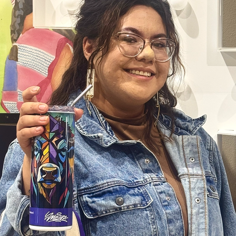 travel mug with colorful RedCan 2025 artwork printed on it